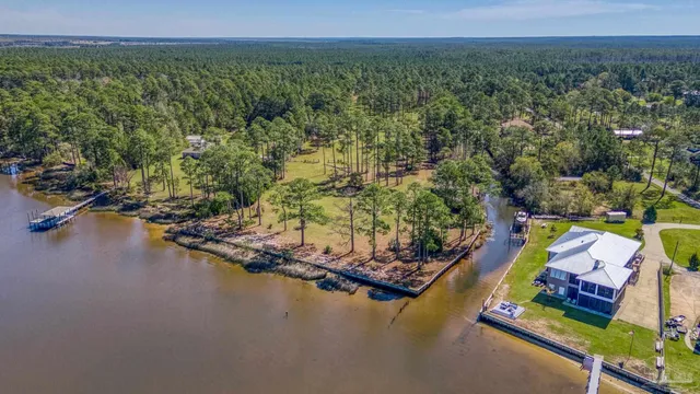 an aerial view of residential houses with outdoor space and swimming pool