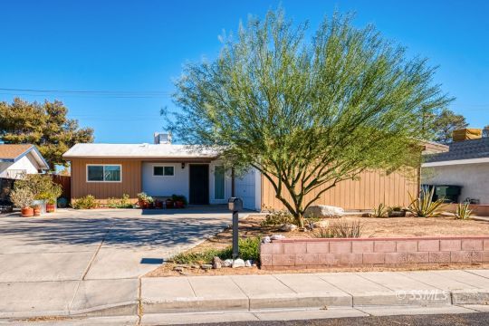 314 Lenore Street Ridgecrest, CA 93555 - Photo 1 of 29 a front view of a house with trees and covered with trees