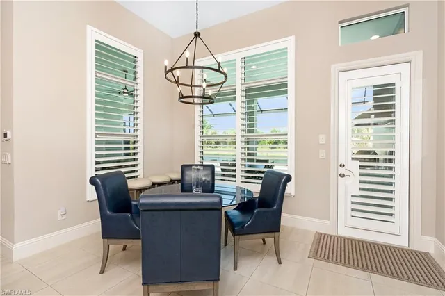 a view of a dining room with furniture wooden floor and chandelier