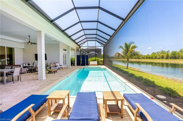 a swimming pool with lawn chairs and wooden floor