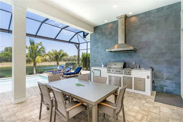 a kitchen with a stove a table and chairs in it
