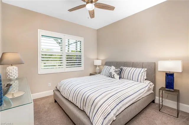a large bed sitting in a bedroom next to a lamp