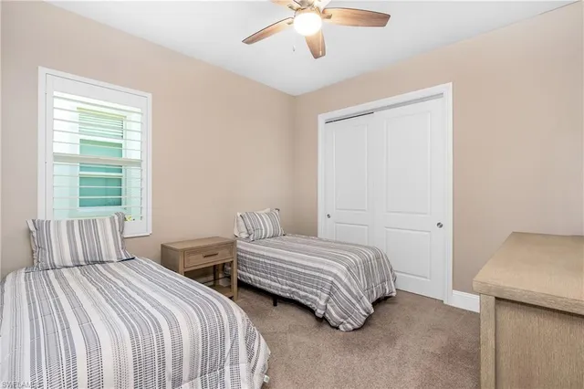 a bedroom with two beds and a chandelier