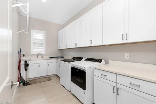 a kitchen with cabinets appliances a sink and a window
