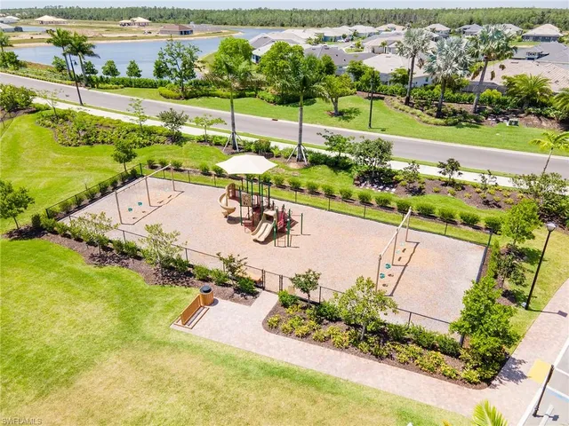 an aerial view of a house with a garden and lake view