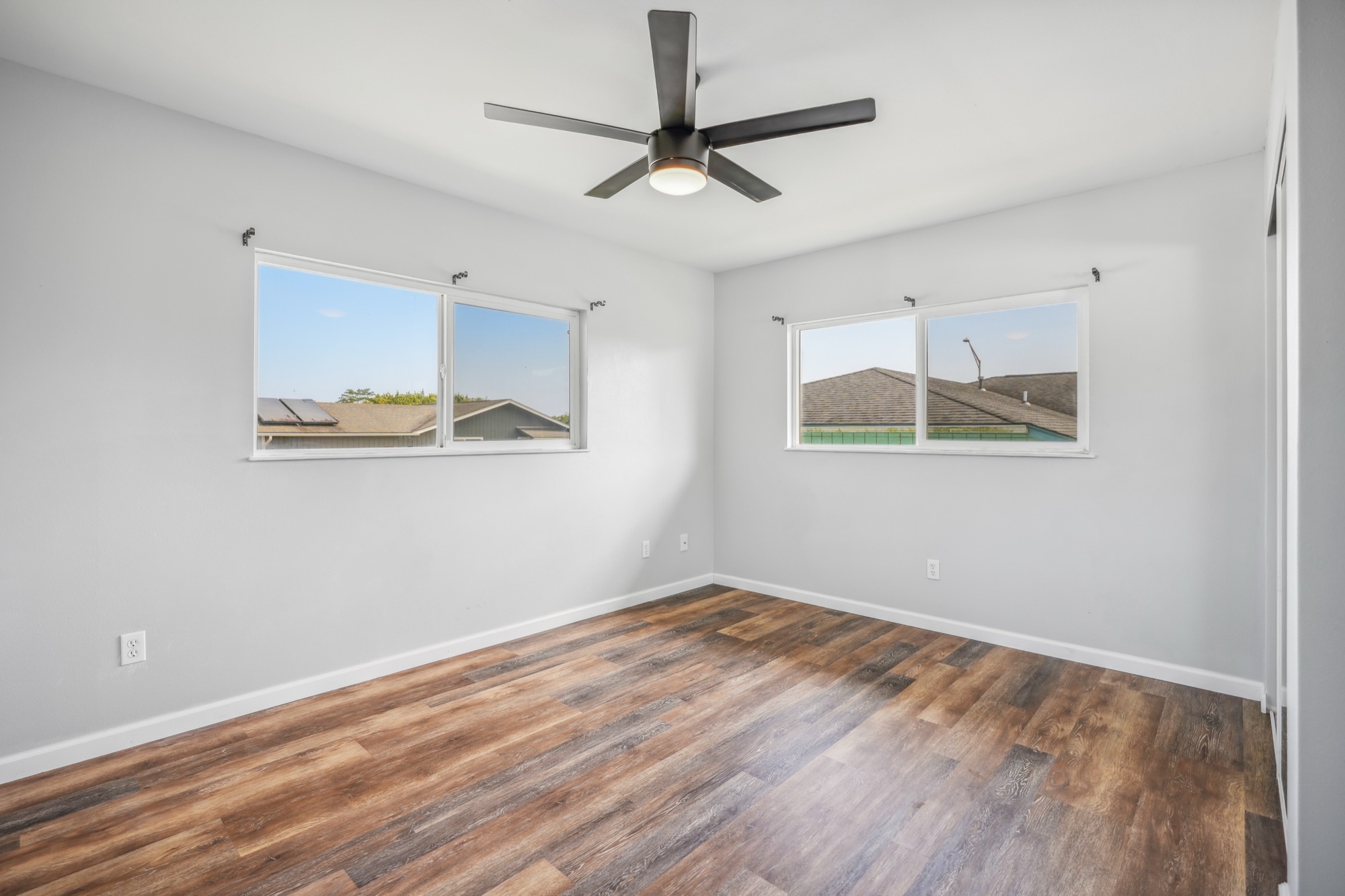 1974 Nana Pali Road Lihue, HI 96766 - Photo 21 of 28 a view of a room with wooden floor and a ceiling fan