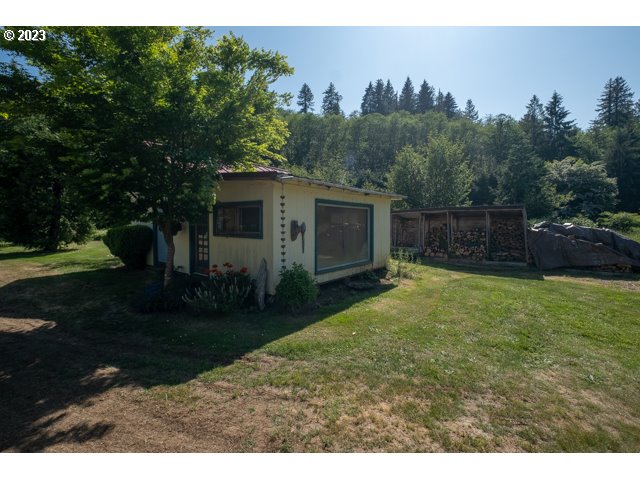 32175 Upper Nestucca River Road Beaver, OR 97108 - Photo 11 of 21 a backyard of a house with plants and large trees