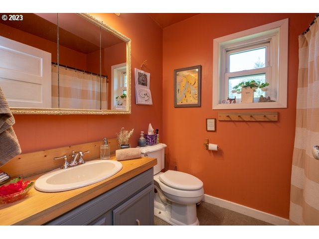 32175 Upper Nestucca River Road Beaver, OR 97108 - Photo 15 of 21 a bathroom with a granite countertop sink mirror vanity and toilet