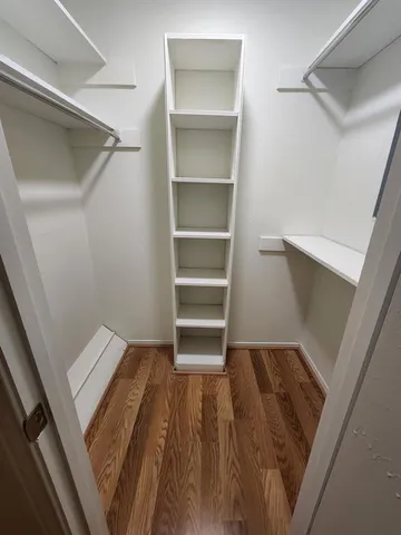 a view of wooden floor and windows in a room