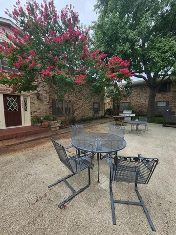 front view of a building with a couple of cars parked in front of a building