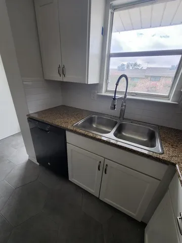 a kitchen with a sink and cabinets