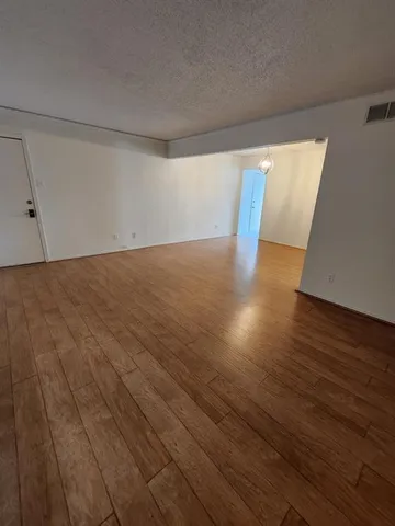 a view of an empty room and wooden floor