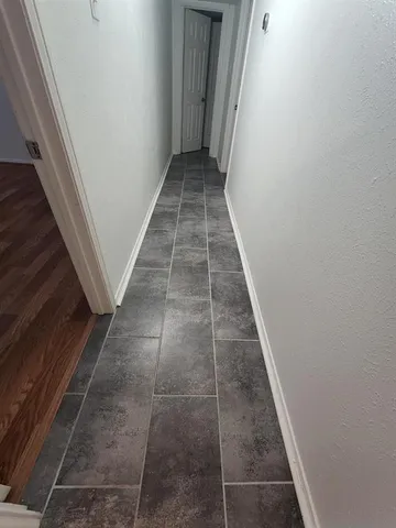 a view of hallway with wooden floor