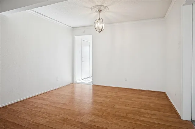 a view of a room with wooden floor and white walls