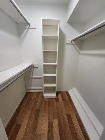a view of walk in closet with empty racks