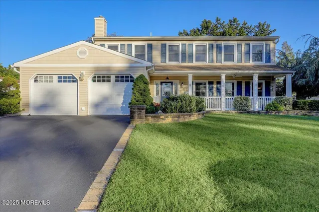 a front view of a house with a yard table and chairs