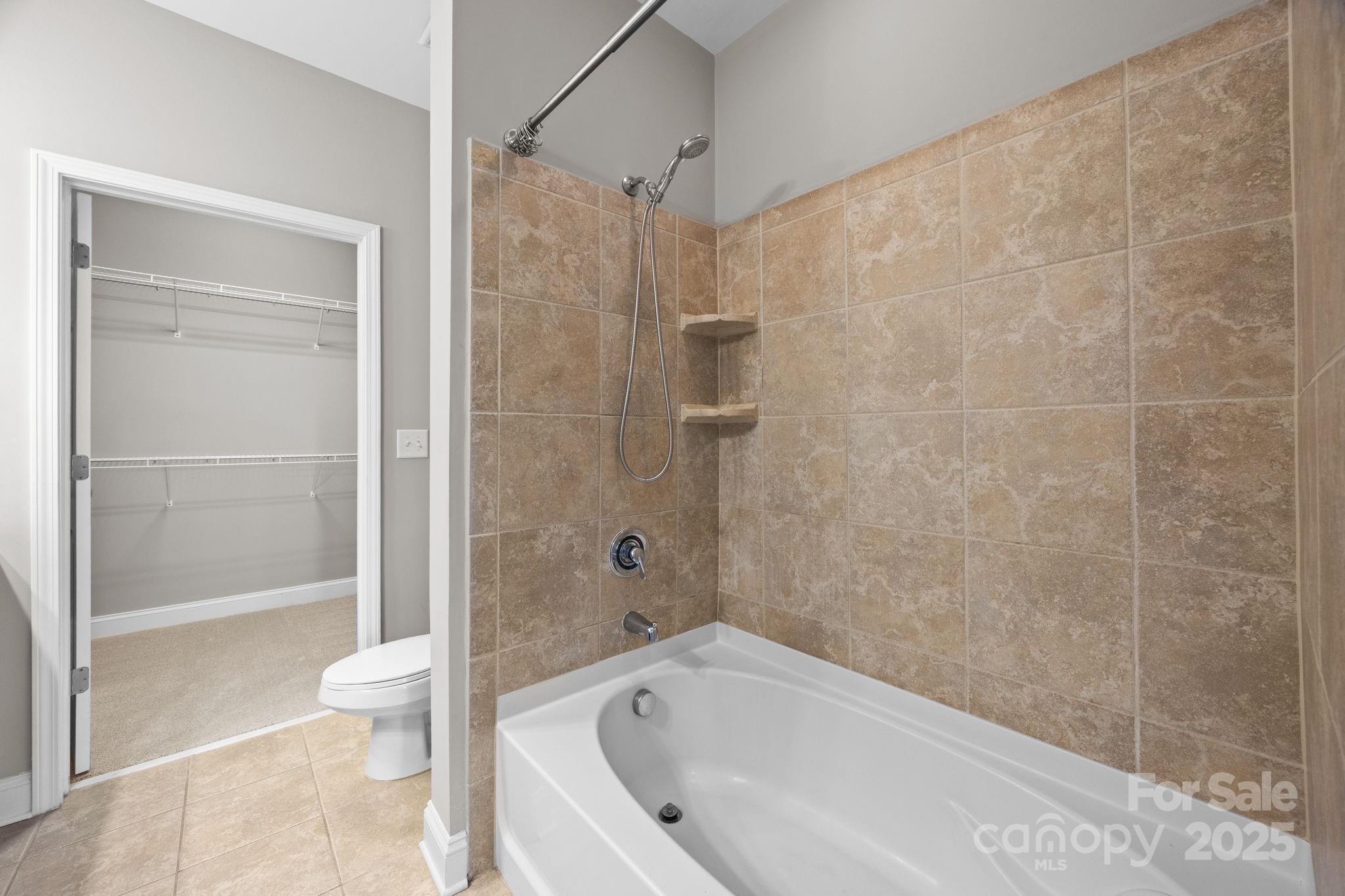 1000 East Woodlawn Road, Unit 413 Charlotte, NC 28209 - Photo 14 of 32 a bathroom with a bathtub and a shower