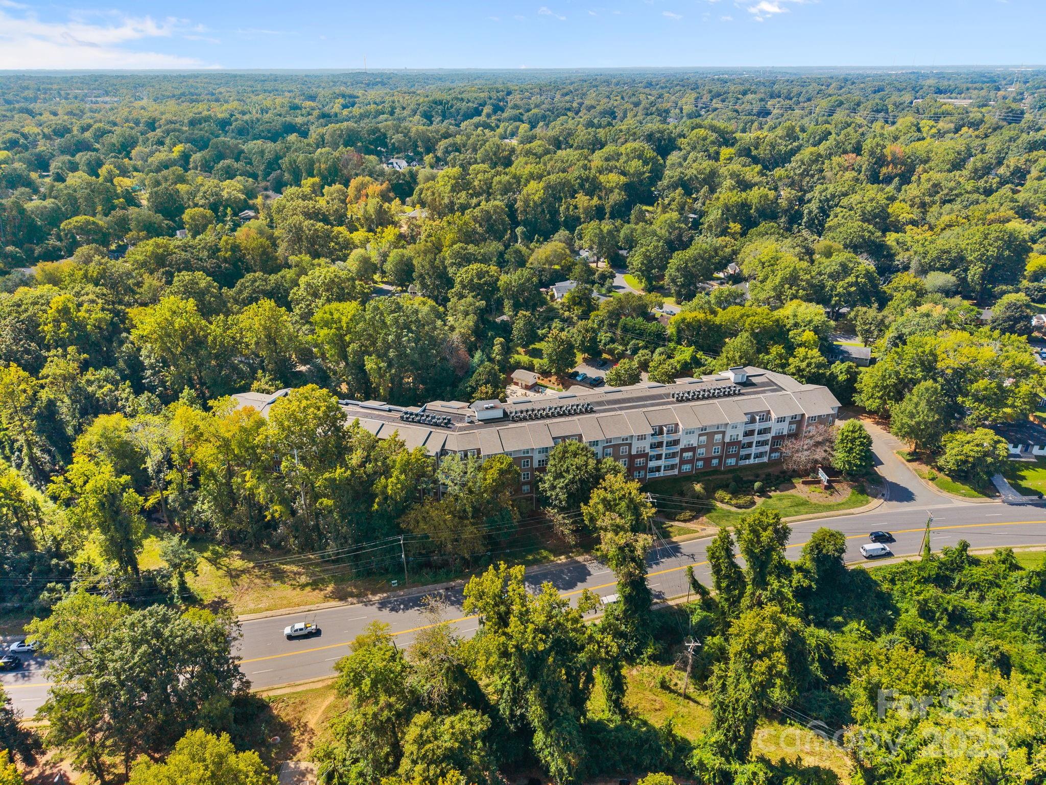 1000 East Woodlawn Road, Unit 413 Charlotte, NC 28209 - Photo 2 of 32 an aerial view of a houses with a yard