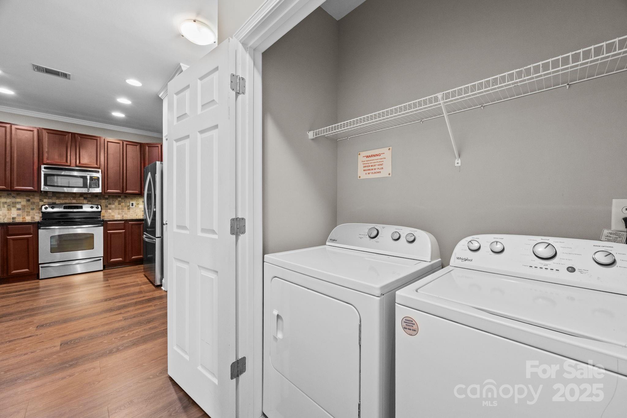 1000 East Woodlawn Road, Unit 413 Charlotte, NC 28209 - Photo 21 of 32 a view of storage and utility room with washer and dryer