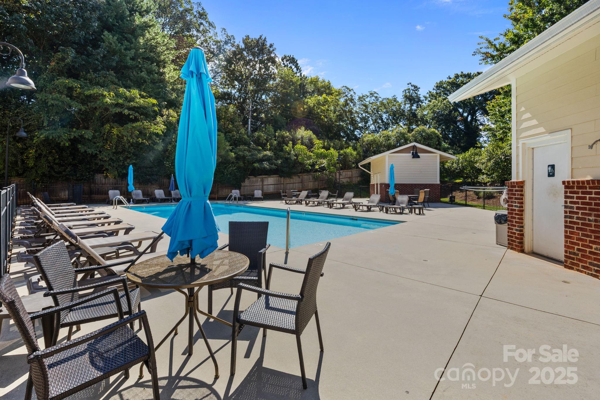 1000 East Woodlawn Road, Unit 413 Charlotte, NC 28209 - Photo 28 of 32 a view of a patio with a table and chairs