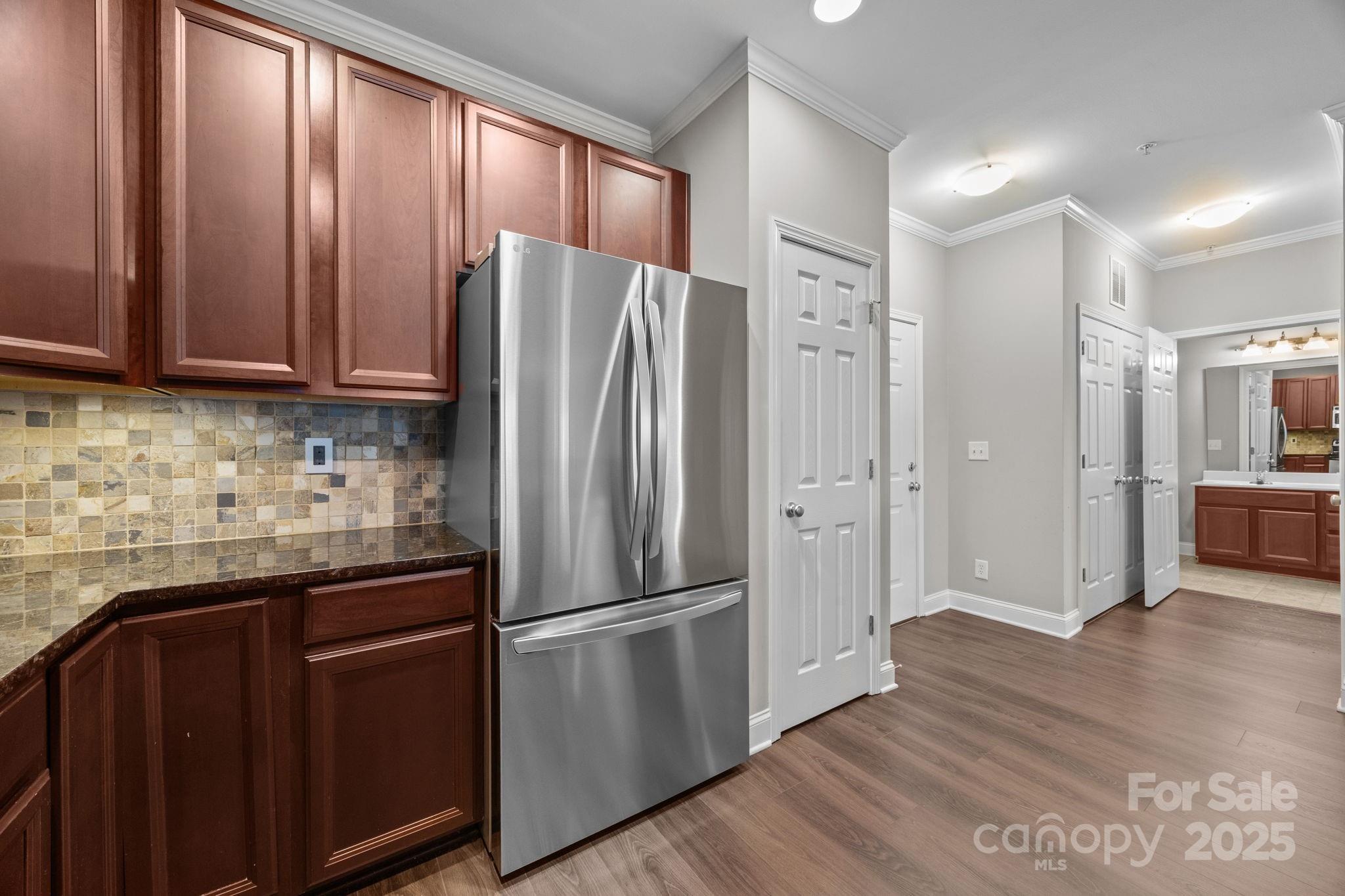 1000 East Woodlawn Road, Unit 413 Charlotte, NC 28209 - Photo 6 of 32 a kitchen with stainless steel appliances granite countertop a refrigerator and a sink