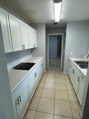 a kitchen with a cabinets and white appliances