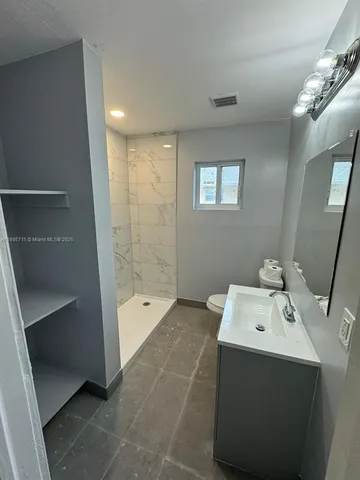 a bathroom with a bathtub sink and mirror