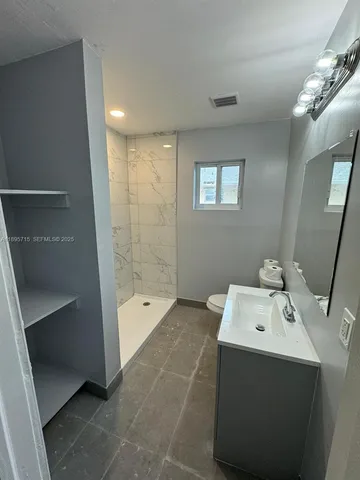 a bathroom with a bathtub sink and mirror
