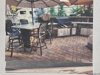 a view of outdoor dining space with a patio