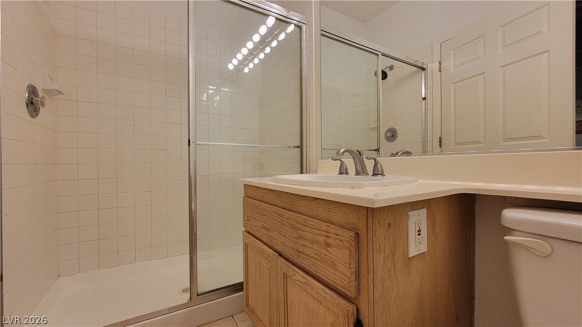 3320 South Fort Apache Road, Unit 111 Las Vegas, NV 89117 - Photo 9 of 12 A well-appointed bathroom with a tiled shower and functional vanity for daily routines.