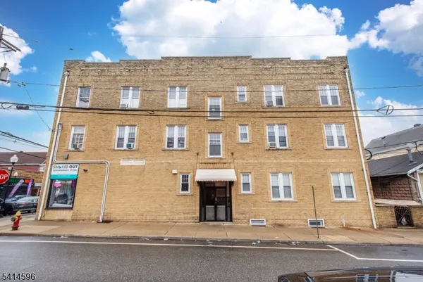 a front view of a building with parking
