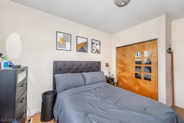 a bedroom with a large bed and a window