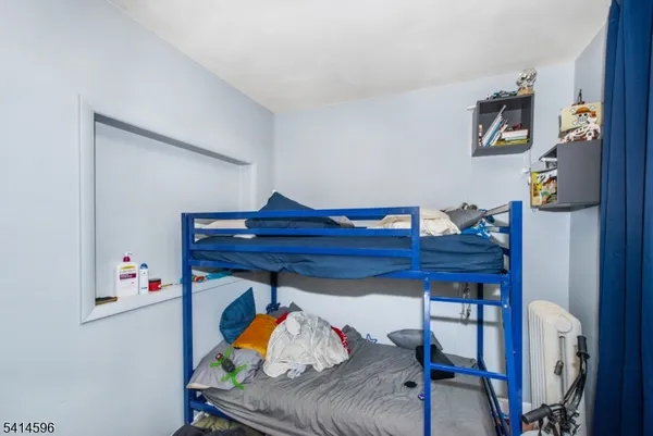 a bed room with furniture and wooden floor