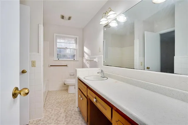 a bathroom with a sink double vanity and a mirror
