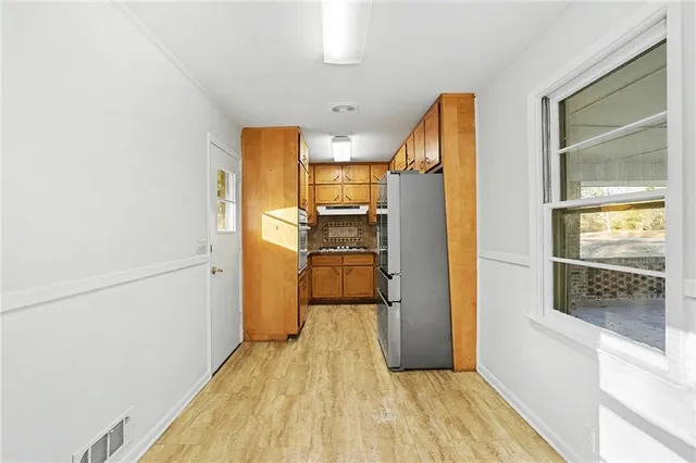 a view of a kitchen from the hallway
