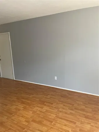a view of an empty room and wooden floor