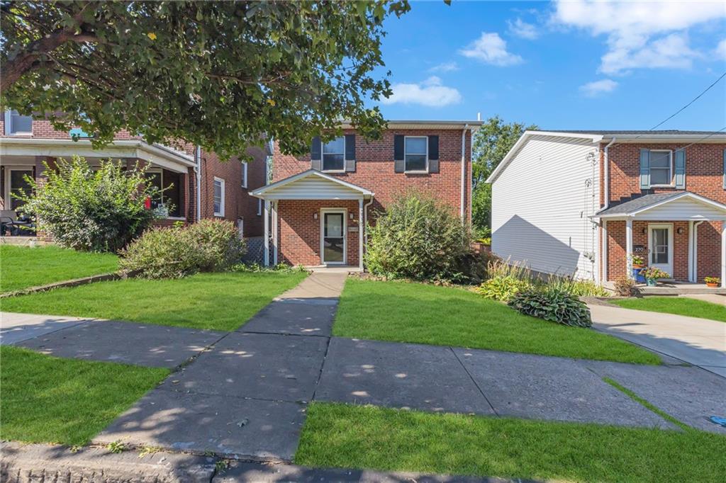 a front view of a house with a yard