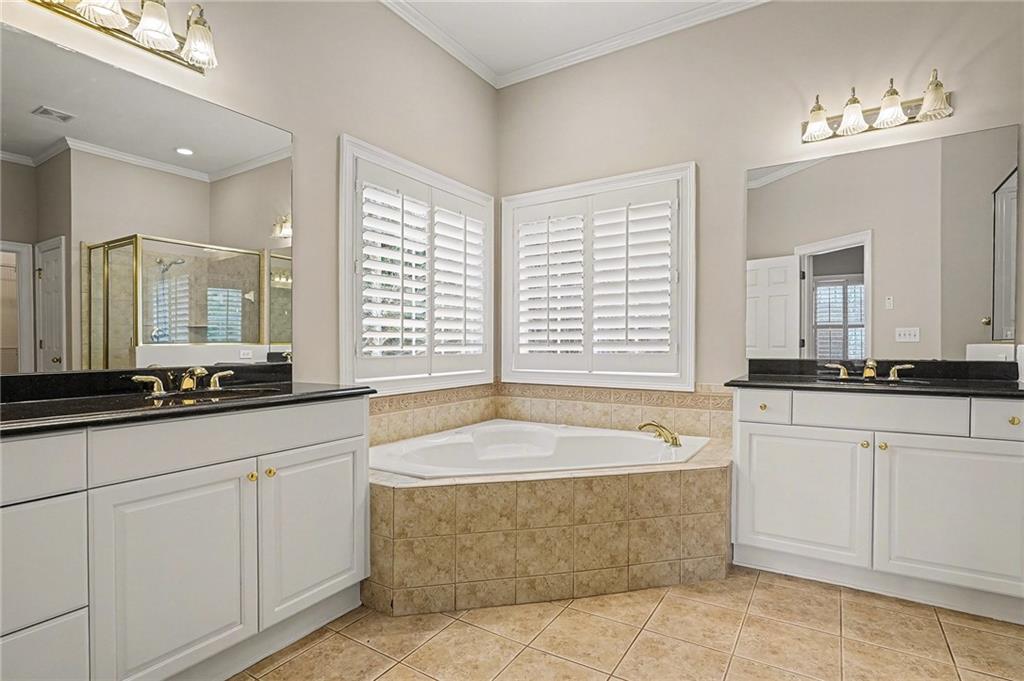 25 Inverleigh Row Covington, GA 30014 - Photo 13 of 28 a spacious bathroom with sinks mirror and a bathtub