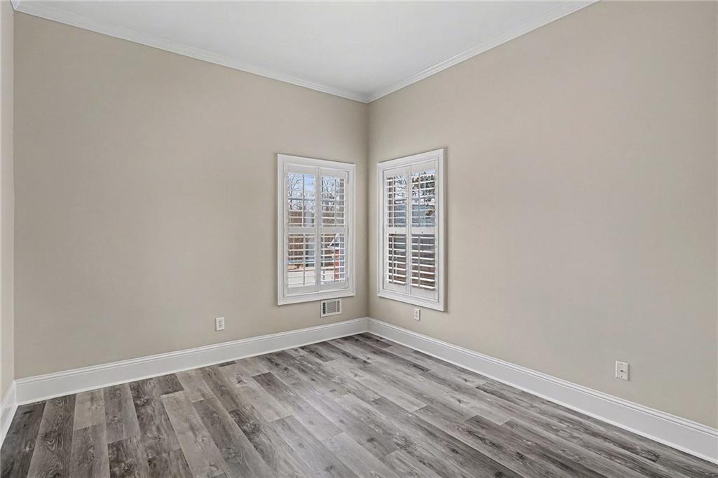25 Inverleigh Row Covington, GA 30014 - Photo 19 of 28 an empty room with wooden floor and windows