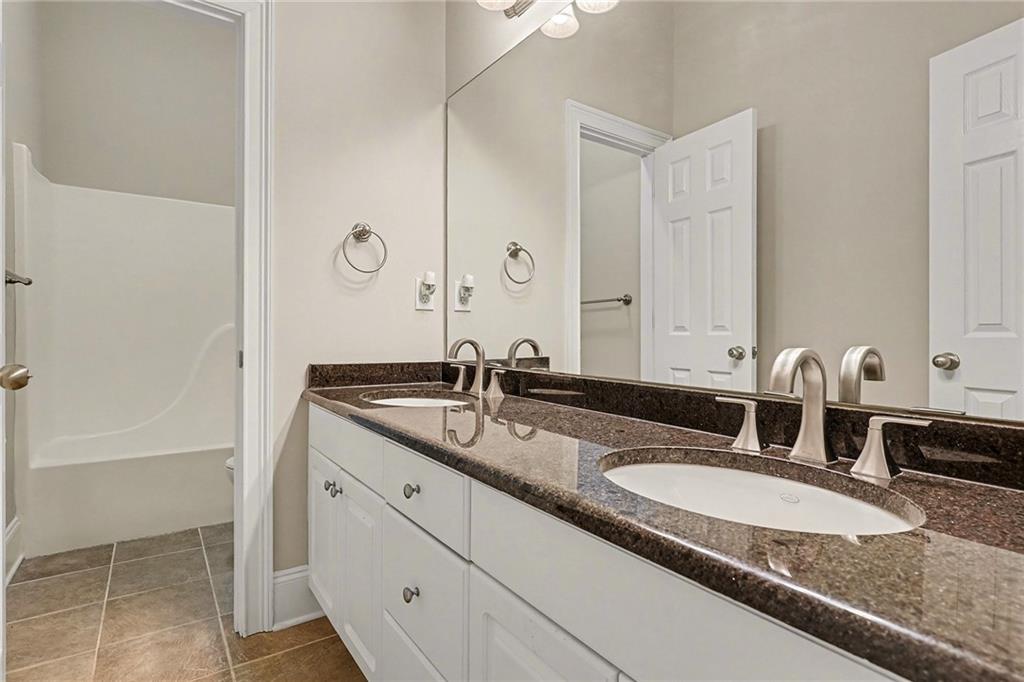25 Inverleigh Row Covington, GA 30014 - Photo 20 of 28 a bathroom with a granite countertop sink and a mirror