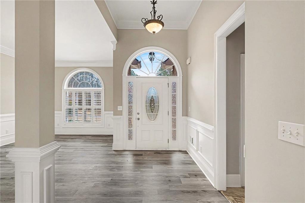 25 Inverleigh Row Covington, GA 30014 - Photo 2 of 28 an empty room with wooden floor fan and windows