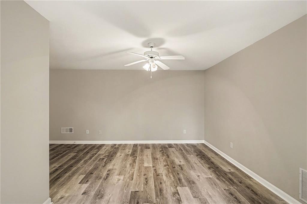 25 Inverleigh Row Covington, GA 30014 - Photo 23 of 28 a view of a room with wooden floor and a ceiling fan