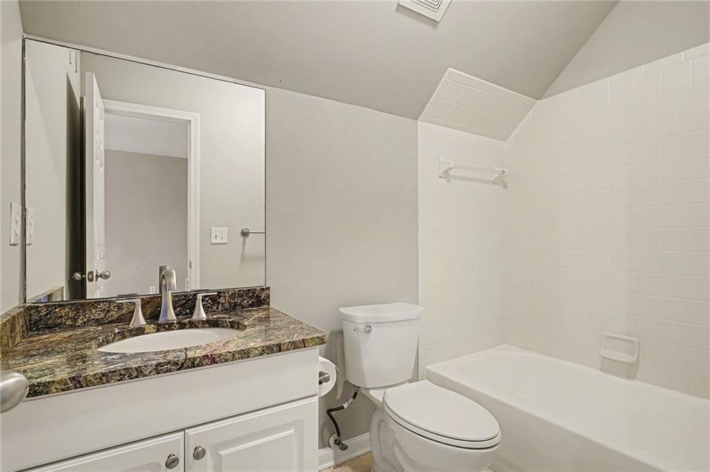 25 Inverleigh Row Covington, GA 30014 - Photo 24 of 28 a bathroom with a granite countertop sink toilet mirror and shower