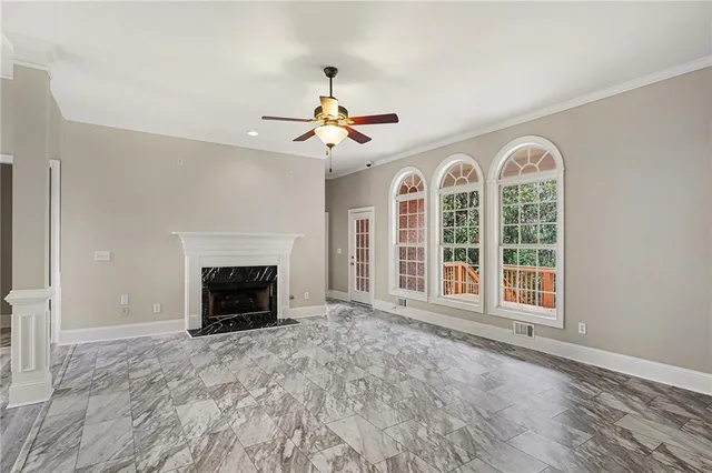 a view of an empty room with a fireplace and a window
