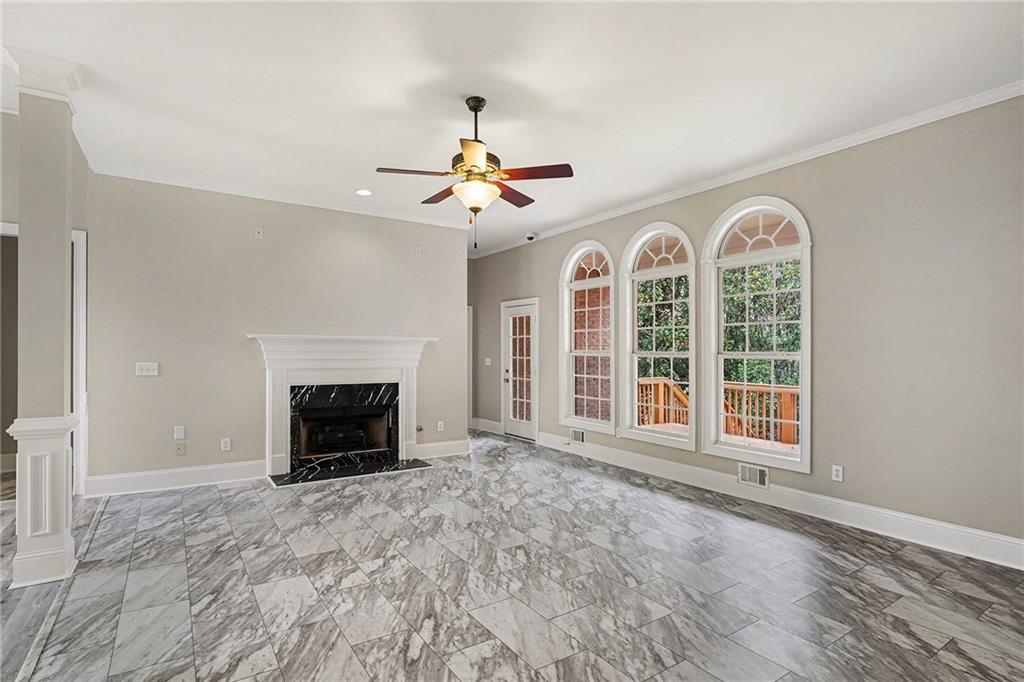 25 Inverleigh Row Covington, GA 30014 - Photo 4 of 28 a view of an empty room with a fireplace and a window