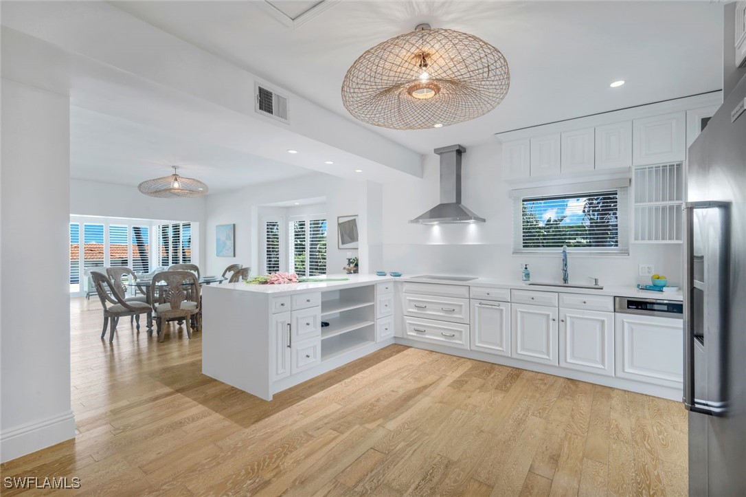 513 Lighthouse Way Sanibel, FL 33957 - Photo 13 of 44 a kitchen with stainless steel appliances granite countertop a stove and cabinets