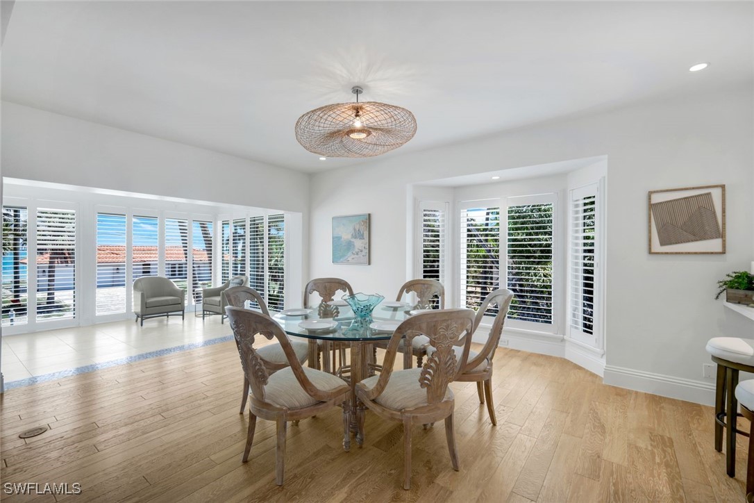 513 Lighthouse Way Sanibel, FL 33957 - Photo 14 of 44 a dining room with furniture window and wooden floor