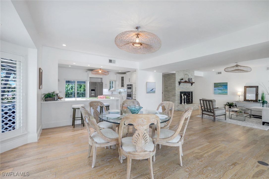 513 Lighthouse Way Sanibel, FL 33957 - Photo 15 of 44 a dining room with furniture a window and wooden floor