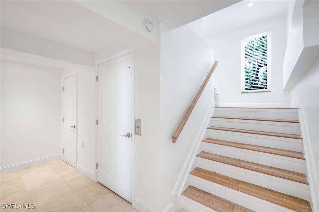 513 Lighthouse Way Sanibel, FL 33957 - Photo 19 of 44 a view of staircase with window and hardwood floor