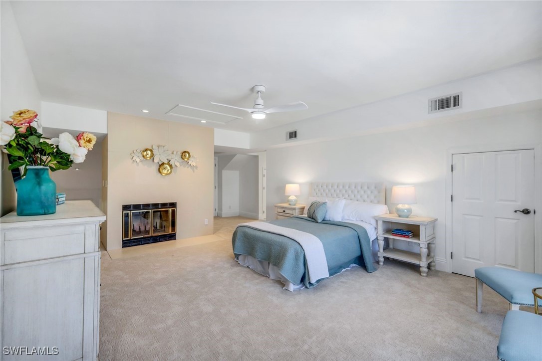 513 Lighthouse Way Sanibel, FL 33957 - Photo 21 of 44 a spacious bedroom with a bed and a couch